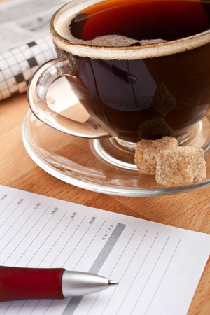 breakfast with coffee, newspaper and a notepadの写真素材