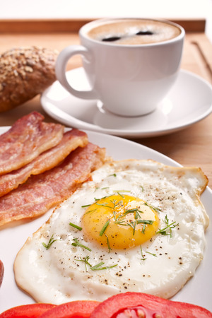 classic breakfast with fried egg, sausages, bacon and coffeeの写真素材