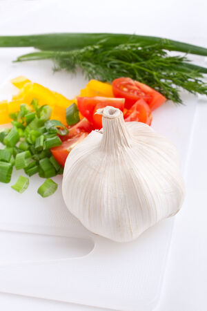 Vegetables on a plastic chopping boardの写真素材