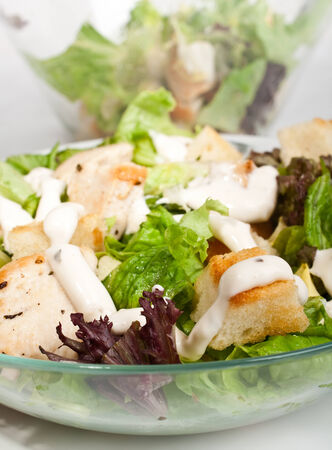 traditional caesar salad in two bowlsの写真素材