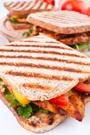 three grilled chicken sandwiches in perspectiveの写真素材