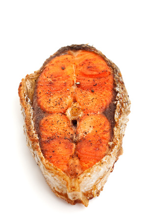 fried salmon steak on white backgroundの写真素材