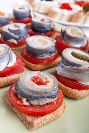 group of small sandwiches with tomatoes and norwegian herringの写真素材