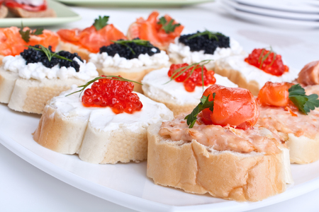 large group of small sandwiches with red and black caviar and salmonの写真素材