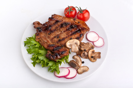 one serving of pork chop with mushrooms and raddishの写真素材