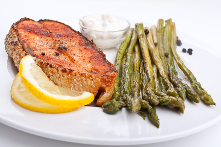 grilled salmon with asparagus, lemon and cream sauceの写真素材