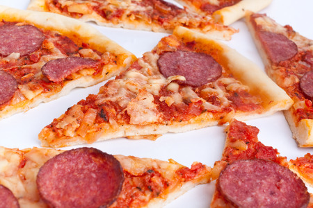 sliced classic salami and cheese pizzaの写真素材