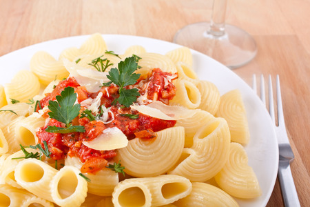 close-up of a serving of pasta with tomato sauce and cheeseの写真素材