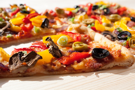 sliced colorful vegetable pizzaの写真素材