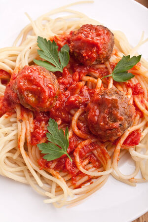 three meatballs with tomato sauce, spaghetti and parsleyの写真素材