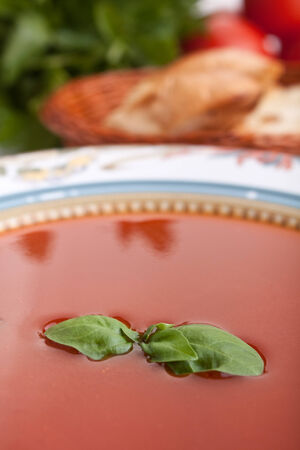 close up of tomato soup plate with basilの写真素材