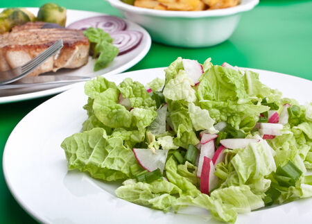 salad with pork chops with fries and brussels sproutsの写真素材