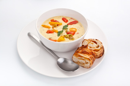 serving of cheese and vegetable cream soup on whiteの写真素材