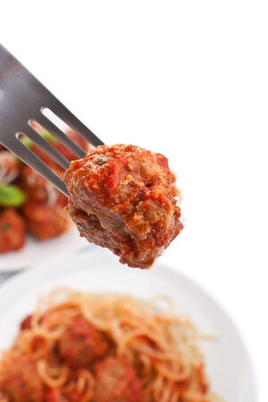 meatball on a fork with plates of meatball spaghettiの写真素材