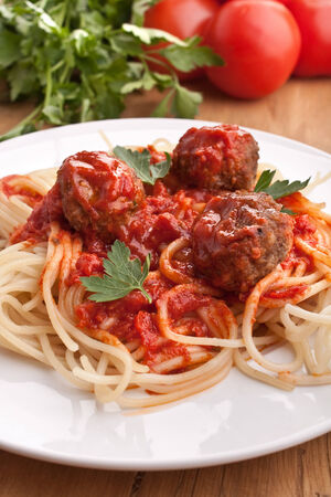 three meatballs with tomato sauce, spaghetti and parsleyの写真素材