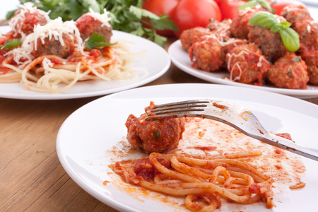 three servings of meatballs with tomato sauce, spaghetti and parsleyの写真素材