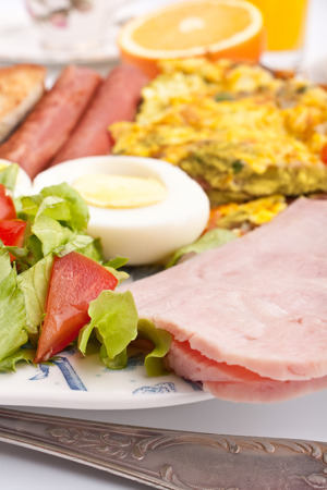 healthy breakfast with omelette, sausages, salad ad hamの写真素材
