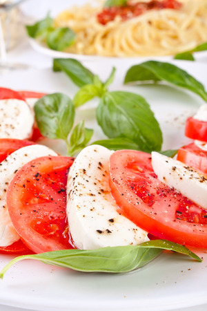 classic caprese salad and pasta with tomato sauceの写真素材