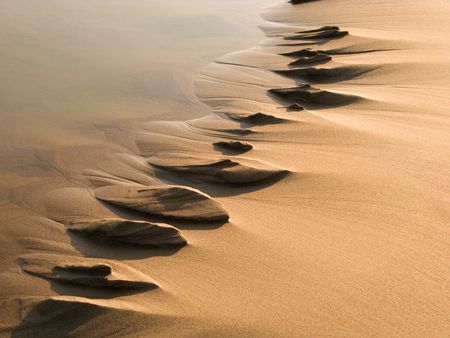 Water created a pattern on sand