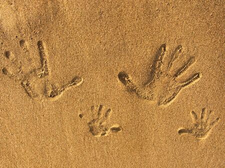 the print of hands on the sandの写真素材