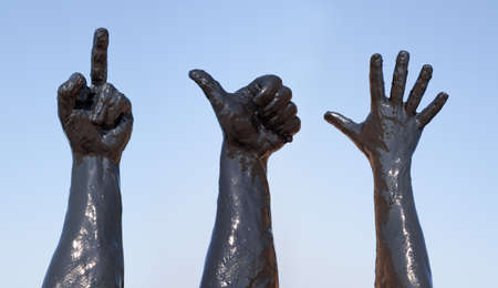 Dirty hands against the blue skyの写真素材