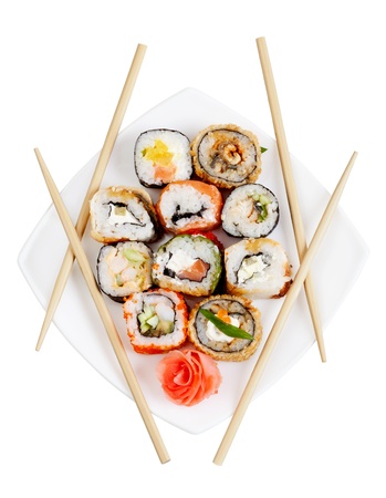 Sushi rolls on the plate with chopsticks, isolated on whiteの写真素材