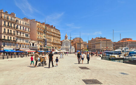 MARSEILLE - JULY 5, 2014: Old port with people walking along the promenadewith and church of Saint Ferreol les Augustins in the on July 5, 2014, Marseille.のeditorial素材