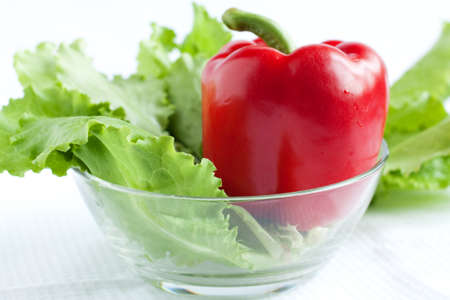Whole red pepper and lettuce salad bowl in a transparentの写真素材