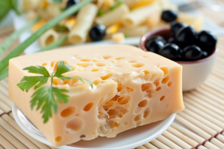 Piece of of cheese and olives, closeupの写真素材