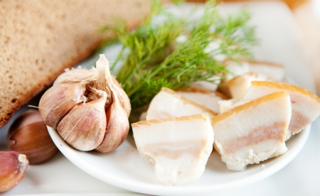 Chunks of fresh bacon and garlic with breadの写真素材