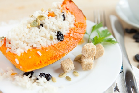 Baked pumpkin with rice and raisins no white dishの写真素材