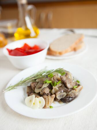 Plate full of delicious mushrooms, interior of the kitchen in the backgroundの写真素材