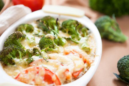 Gratin with cheese and broccoli, tomatoes, food closeupの写真素材