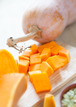 pumpkin, its seeds, pieces on the board, raw foodの写真素材