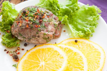 piece of grilled juicy meat with orange, close upの写真素材