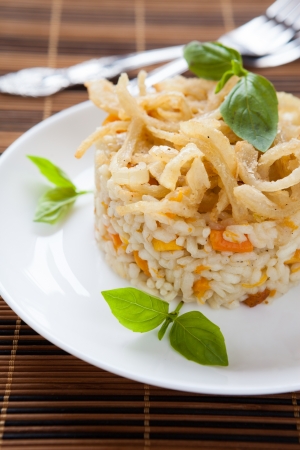 risotto with pumpkin on a white dish, closeupの写真素材