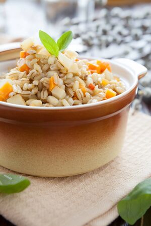 nourishing barley porridge with root vegetables, closeupの写真素材