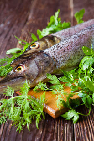 Raw fish and greens on the table, closeupの写真素材