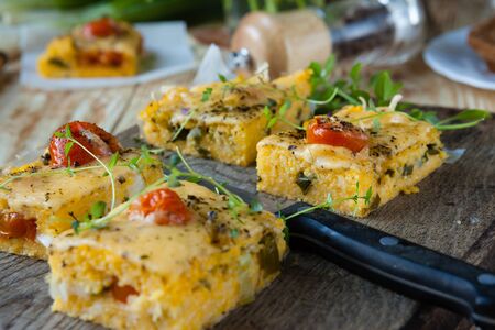 polenta with cheese cut into small squares on the board, closeup