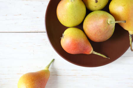 ripe juicy pear and a clay plate, top