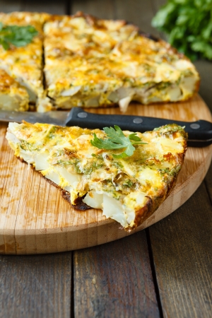 Frittata slices on a cutting board and knife, food close upの写真素材