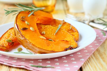 slices of roast pumpkin on a plate, food close upの写真素材