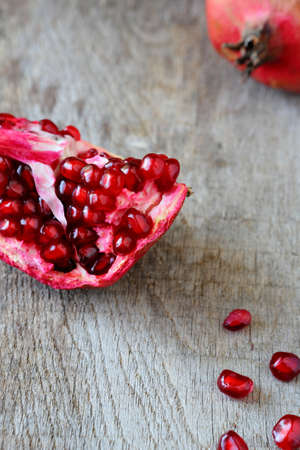 ripe pomegranate on wooden table, foodの写真素材