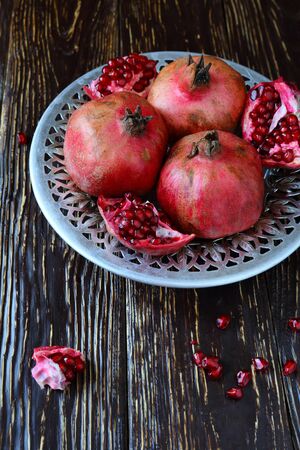 lots of ripe pomegranate in a beautiful bowl, food closeupの写真素材