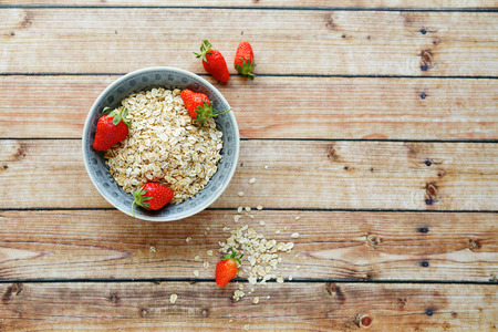 cereal in a bowl and berries, top viewの写真素材