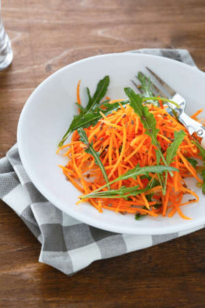 fresh salad with arugula and carrots, food closeupの写真素材