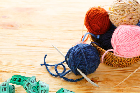 balls of yarn and knitting needles on board, craftの写真素材