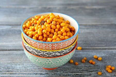 Fresh sea buckthorn in a bowl, closeupの写真素材