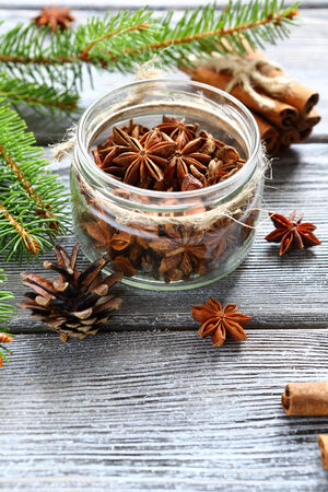Aromatic anise and cinnamon with pine branches on the boards, top viewの写真素材