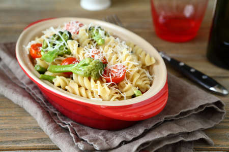 Pasta with grilled broccoli, shredded cheese and tomatoes, delicious italian foodの写真素材